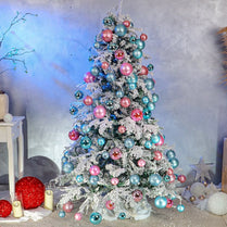 Decorated Christmas tree with colorful ornaments against a neutral background