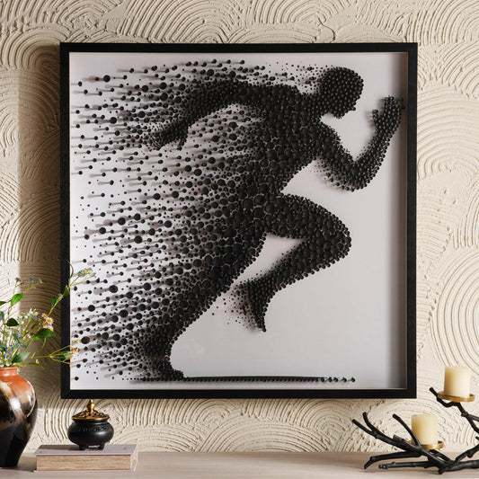 Framed artwork of a running person made from black dots on a white background, displayed on a wall.