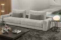 Gray sofa in a modern living room setting with a coffee table and decorative items.