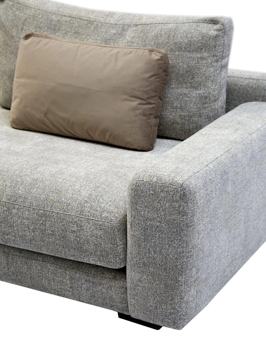 Gray sofa with a brown pillow on a white background
