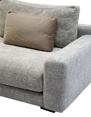 Gray sofa with a brown pillow on a white background