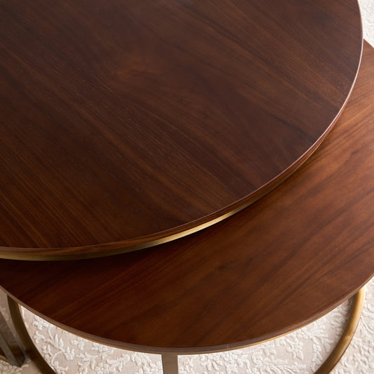 Close-up of two wooden round tables stacked on top of each other.