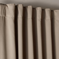 Close-up of beige curtains with a neutral background