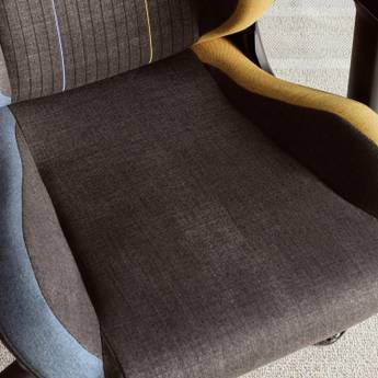 Close-up of a chair with gray cushioned seat and yellow armrests.