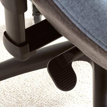 Close-up of a footrest attached to an office chair on a carpeted floor.