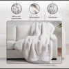 White blanket on a sofa with texture and size details