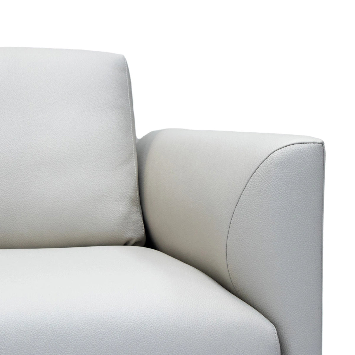 Close-up of a light gray sofa with a white background