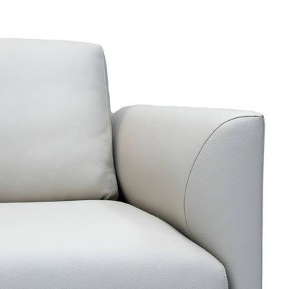 Close-up of a light gray sofa with a white background