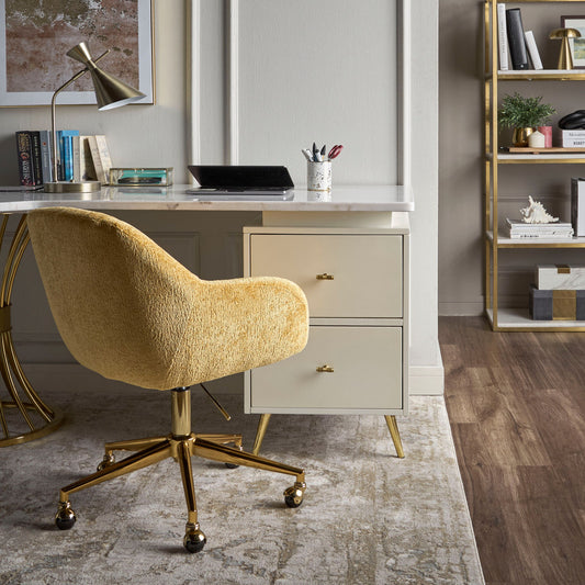Modern home office with a yellow chair, desk, and bookshelf.