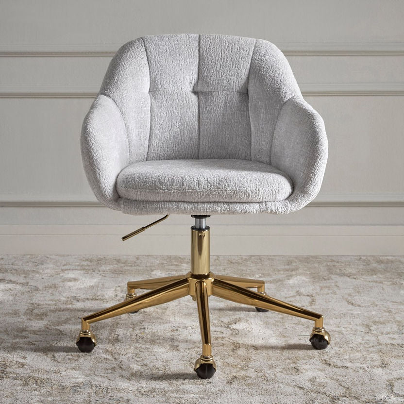 Gray upholstered office chair with gold metal base on a wooden floor.