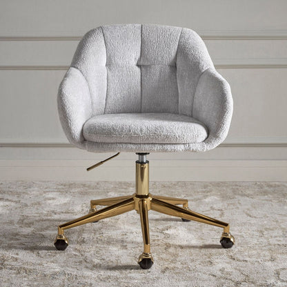Gray upholstered office chair with gold metal base on a wooden floor.