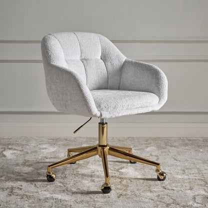 Gray upholstered office chair with gold metal base on a neutral background