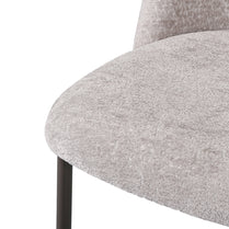Close-up of a gray upholstered chair with a white background