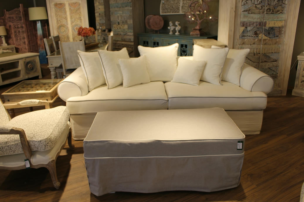 Beige sectional sofa with matching ottoman in a living room setting. Venice Collection Sofa – Deep Comfort for Modern Living | Vella Concept
