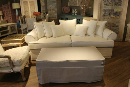Beige sectional sofa with matching ottoman in a living room setting. Venice Collection Sofa – Deep Comfort for Modern Living | Vella Concept