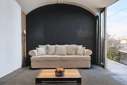 Beige sofa on a patio with a coffee table and outdoor view - Venice Collection Sofa – Deep Comfort for Modern Living | Vella Concept