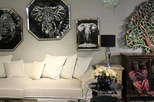 Living room with decorative wall art, a couch, and a lamp. Venice Corner Collection Sofa – Spacious Comfort with Modern Style | Vella Concept