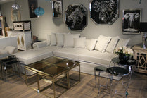Modern living room with a sectional sofa, glass coffee table, and decorative wall art. Venice Corner Collection Sofa – Spacious Comfort with Modern Style | Vella Concept