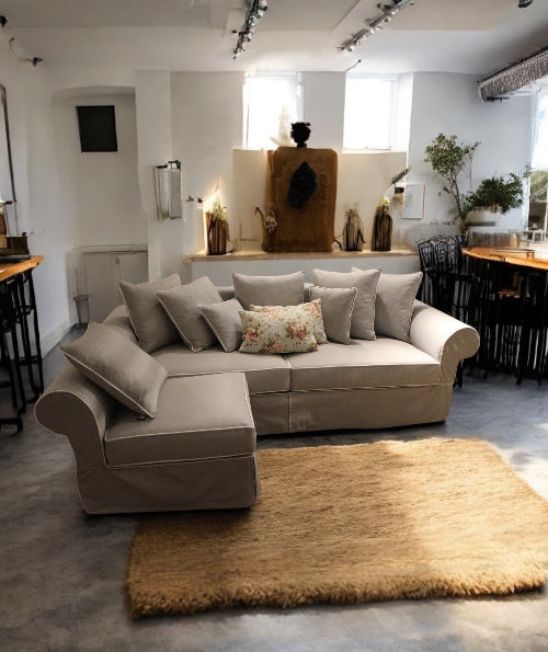 Beige sectional sofa with decorative pillows in a modern living room setting. Venice Corner Collection Sofa – Spacious Comfort with Modern Style | Vella Concept