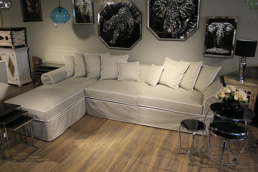 Beige sectional sofa in a living room with decorative wall art and furniture. Venice Corner Collection Sofa – Spacious Comfort with Modern Style | Vella Concept