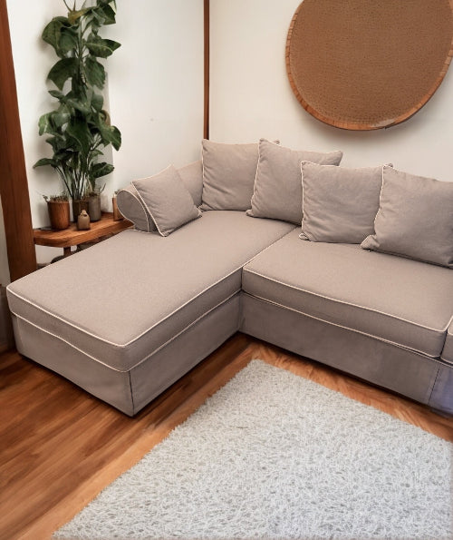 Gray sectional sofa in a living room with a plant and round wall art. Venice Corner Collection Sofa – Spacious Comfort with Modern Style | Vella Concept