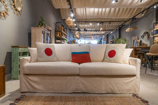Beige sofa with decorative pillows in a store setting. Vienna Collection Sofa – Where Sophistication Meets Comfort | Vella Concept