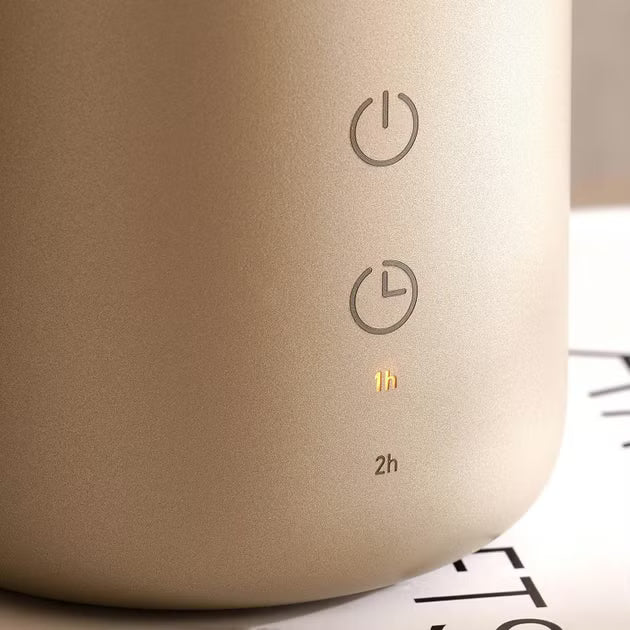 Close-up of a beige electronic device with power and timer symbols on a blurred background