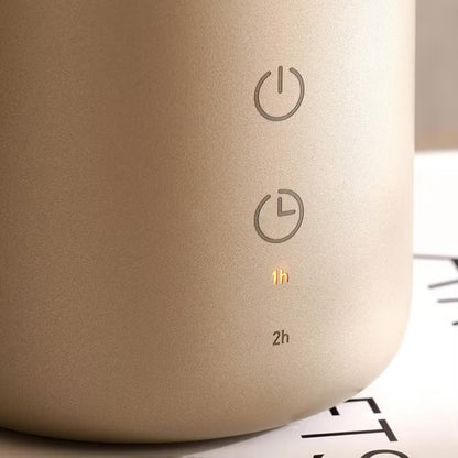 Close-up of a beige electronic device with power and timer symbols on a blurred background