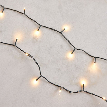 String of small lights on a textured white surface