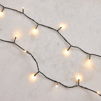 String of small lights on a textured white surface