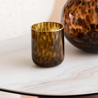 Tortoiseshell-patterned glass on a marble surface