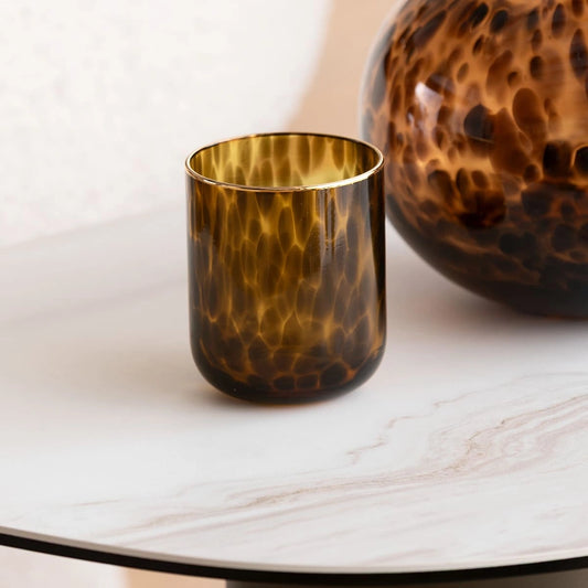 Tortoiseshell-patterned glass on a marble surface