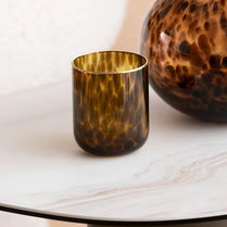 Tortoiseshell-patterned glass on a marble surface