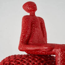 Red sitting sculpture