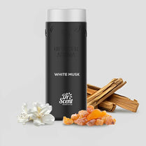 Black diffuser aroma bottle labeled 'White Musk' with flowers and wood sticks on a light gray background