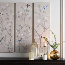 Decorative wall panels with floral and bird patterns on a neutral background.