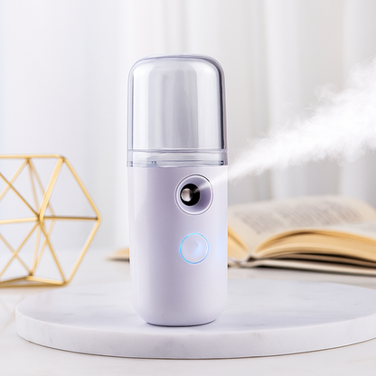 White spray bottle with a blue light on a white surface