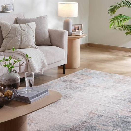 Living room with a gray sofa, coffee table, and decorative items.