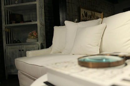 White sofa with cushions in a dimly lit room - Bodrum Collection Sofa – Elegance Meets Everyday Comfort | Vella Concept