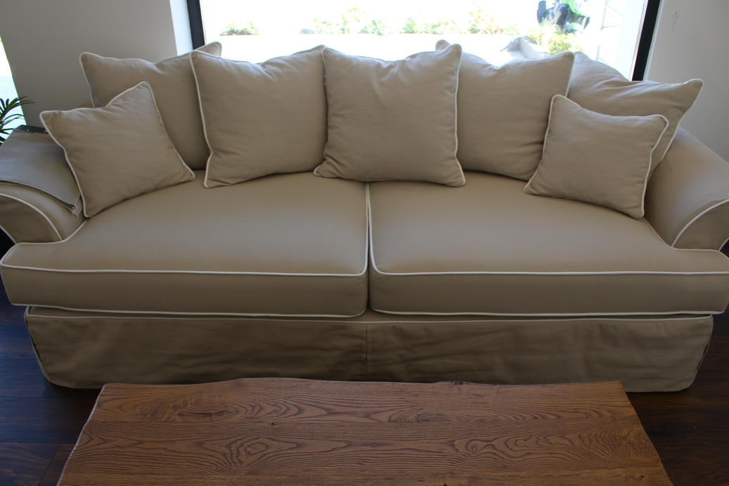 Beige sofa with cushions in a room with a wooden coffee table. Bosphorus Collection Sofa – Minimalist Elegance for Modern Homes | Vella Concept