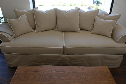 Beige sofa with cushions in a room with a wooden coffee table. Bosphorus Collection Sofa – Minimalist Elegance for Modern Homes | Vella Concept