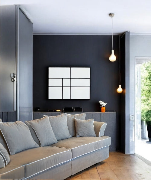 Modern living room with a gray sofa, dark wall, and decorative elements. Bosphorus Collection Sofa – Minimalist Elegance for Modern Homes | Vella Concept