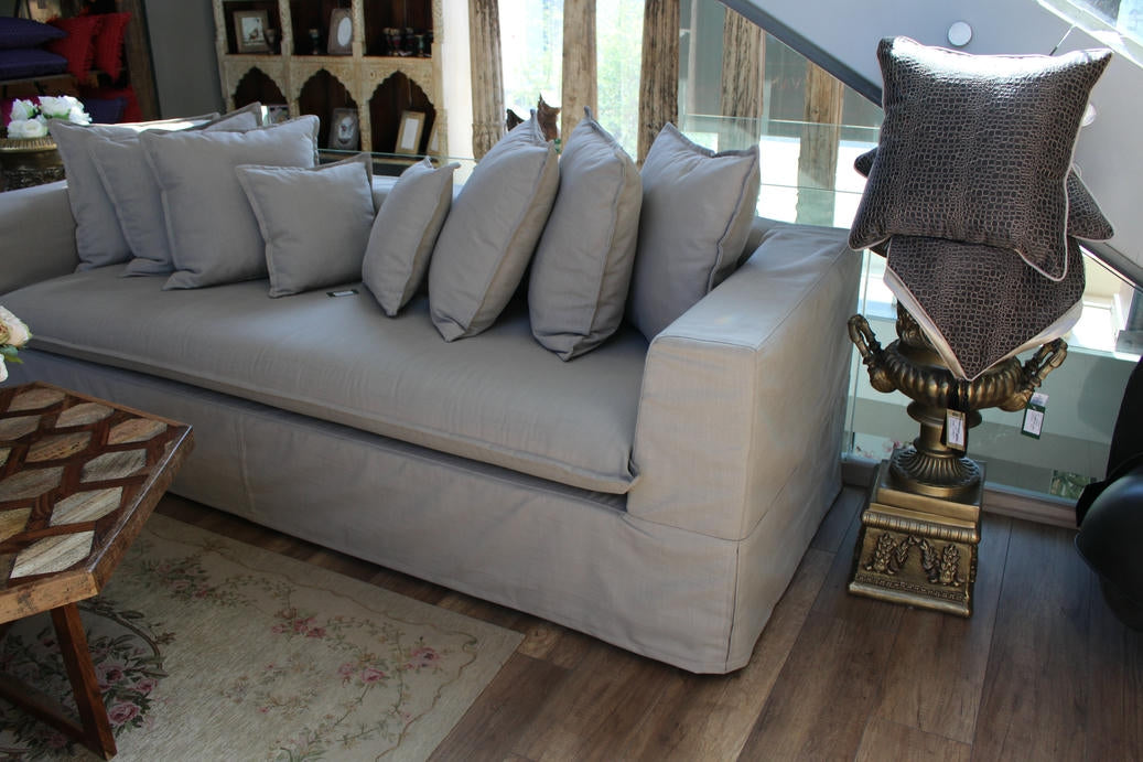 Gray sofa with decorative pillows in a living room setting - Cappadocia Collection Sofa – Simple, Serene & Timeless | Vella Concept