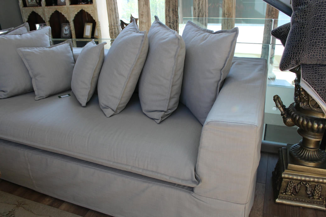Gray sofa with decorative pillows in a room setting. Cappadocia Collection Sofa – Simple, Serene & Timeless | Vella Concept