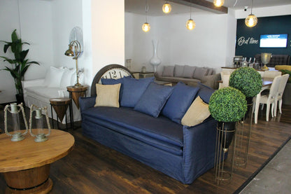 Living room with blue sofa, wooden coffee table, and decorative elements. Istanbul Collection Sofa – Minimal Touch, Maximum Comfort | Vella Concept
