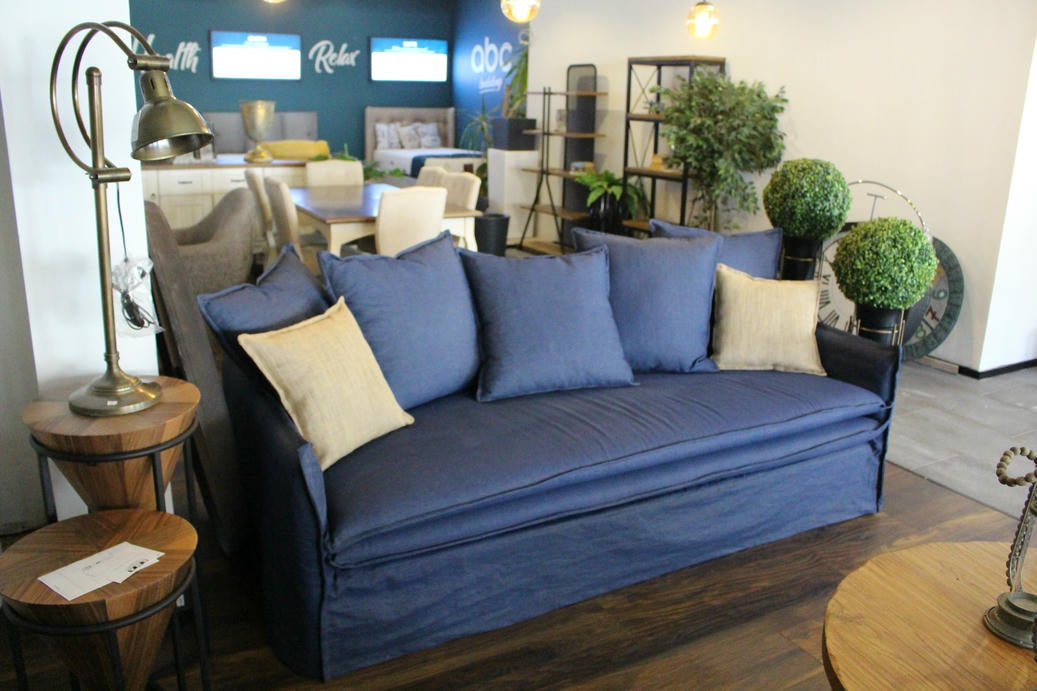 Blue sofa with beige cushions in a room with furniture and decor - Istanbul Collection Sofa – Minimal Touch, Maximum Comfort | Vella Concept