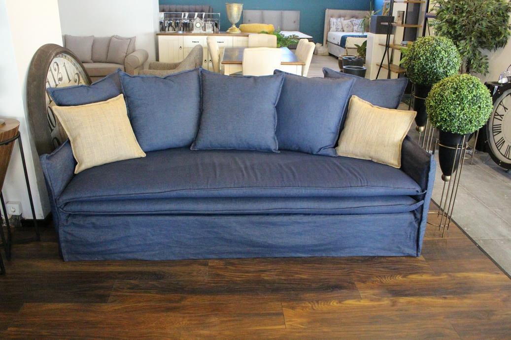 Blue sofa with decorative pillows in a living room setting - Istanbul Collection Sofa – Minimal Touch, Maximum Comfort | Vella Concept